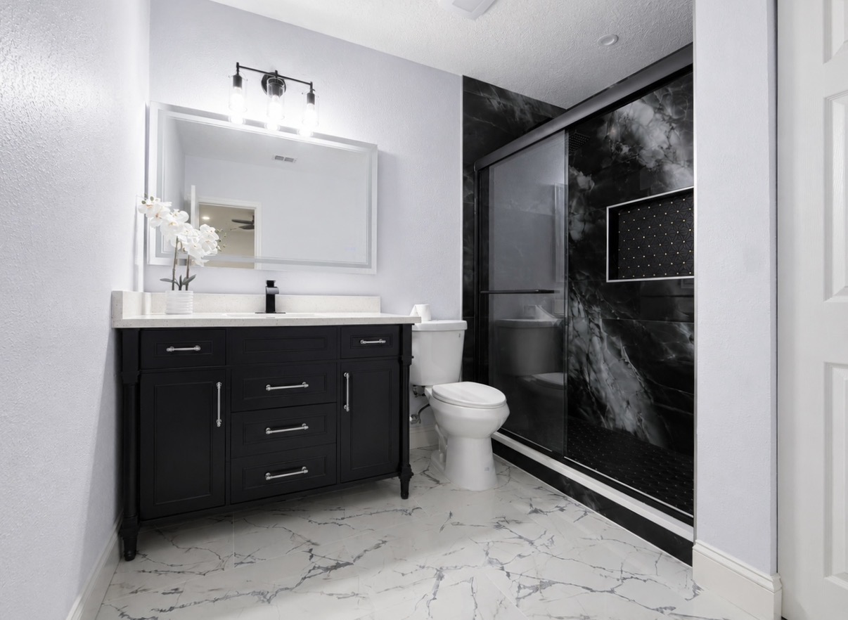 Luxury bathroom with black vanity and marble floor