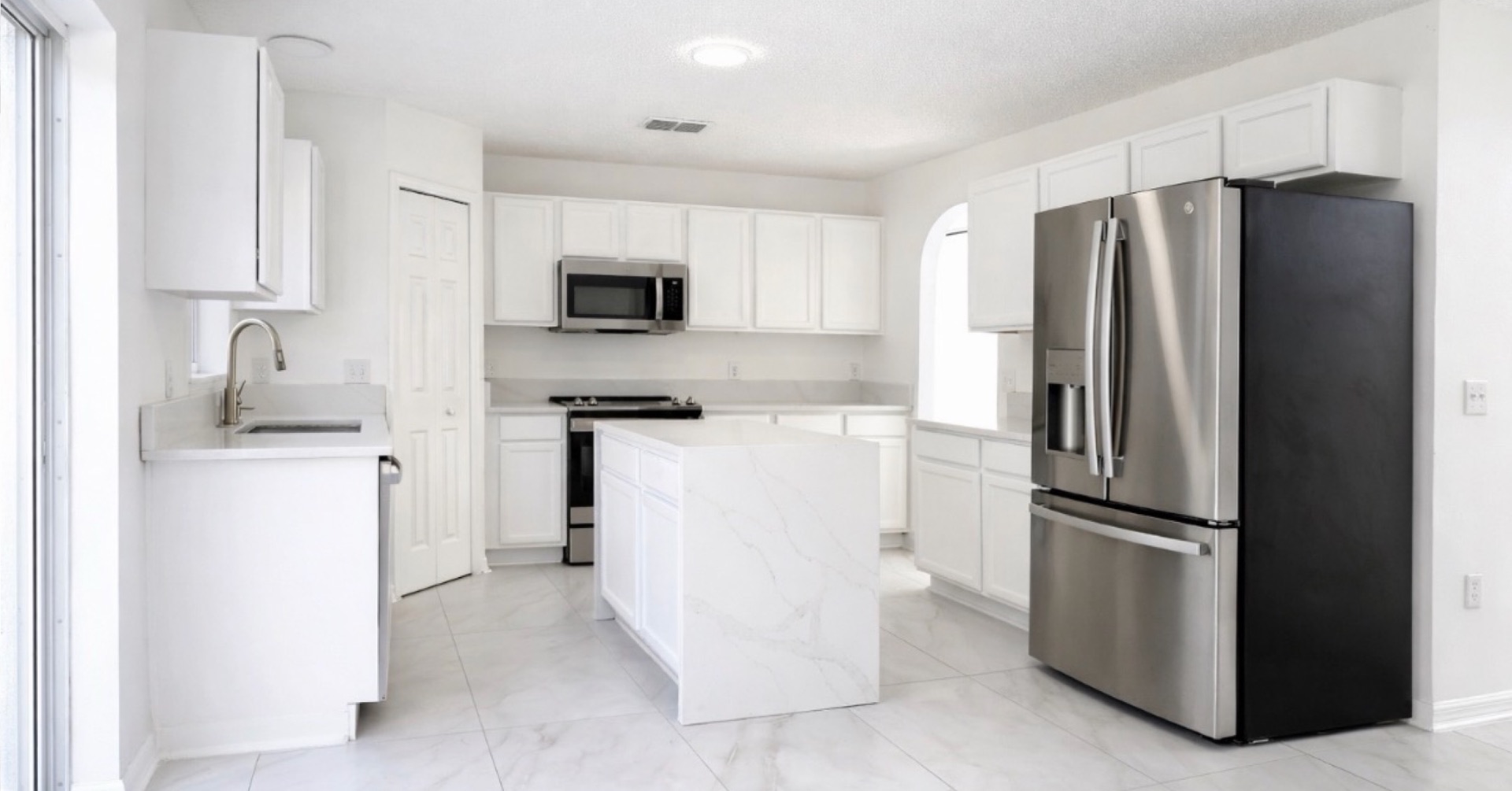Modern white kitchen with marble island